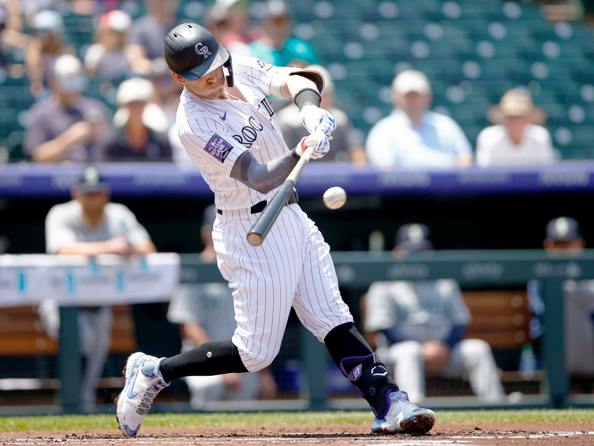 Jul 21, 2021; Denver, Colorado, USA; Colorado Rockies shortstop Trevor Story (27) hits a single in the first inning against the Seattle Mariners at Coors Field.