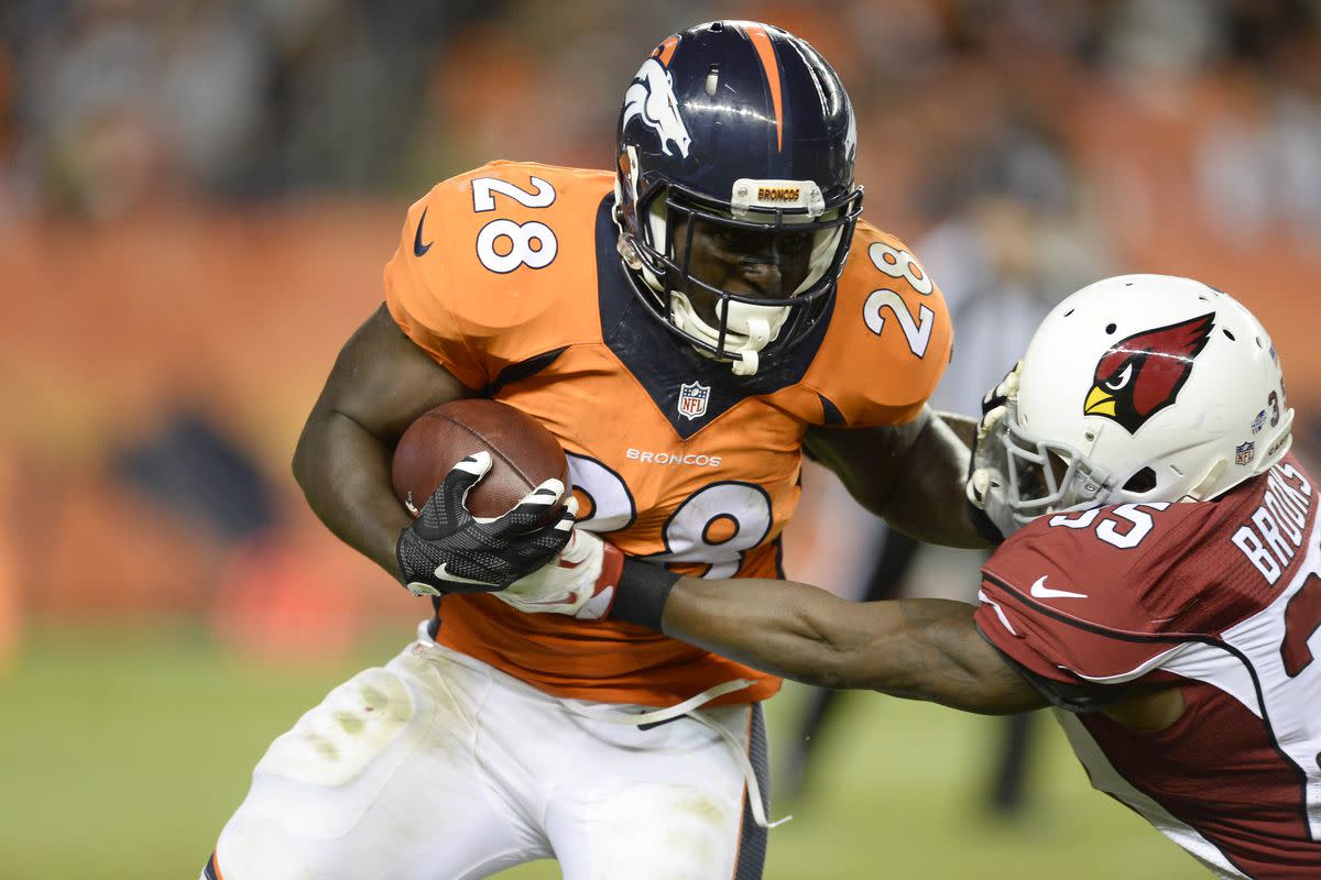 Denver Broncos running back Montee Ball (28) is tackled by Arizona Cardinals defensive back Cariel Brooks (35) in the third quarter of a preseason game at Sports Authority Field at Mile High. The Cardinals defeated the Broncos 22-20.