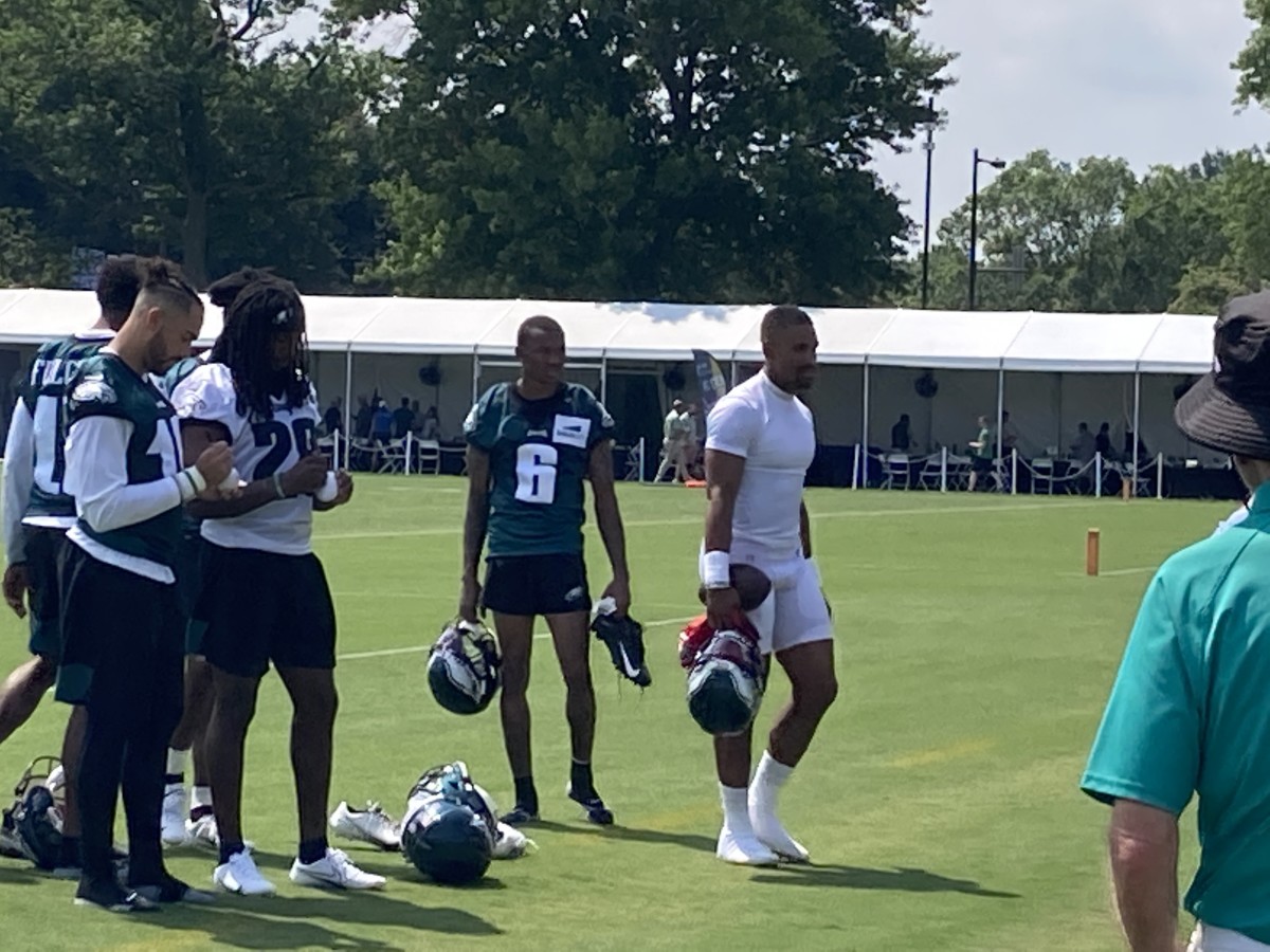 DeVonta Smith (left) and Jalen Hurts lave the field after first day of training camp, July 28, 2021