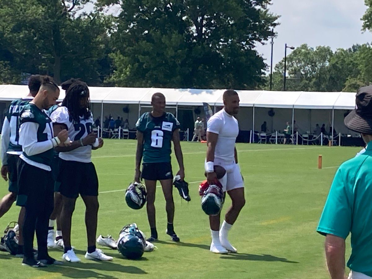 DeVonta Smith (left) and Jalen Hurts lave the field after first day of training camp, July 28, 2021