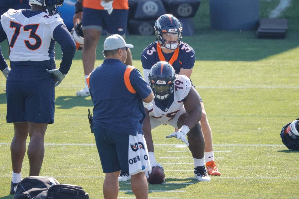 Denver Broncos quarterback Drew Lock (3) behind center Lloyd Cushenberry III (79) during training camp at UCHealth Training Complex.