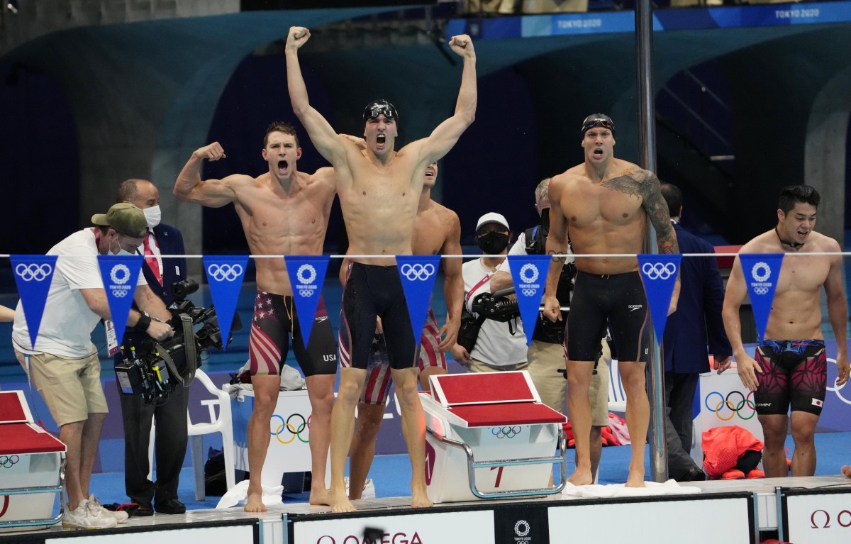 Ryan Murphy (left), Zach Apple and Caeleb Dressel (right) celebrate world-record-time victory. Photo by Rob Schumacher, USA Today. 