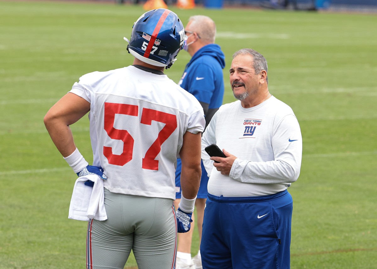 Jul 29, 2021; East Rutherford, NJ, USA; New York Giants general manager Dave Gettleman talks with defensive end Niko Lalos (57) during training camp at Quest Diagnostics Training Center.