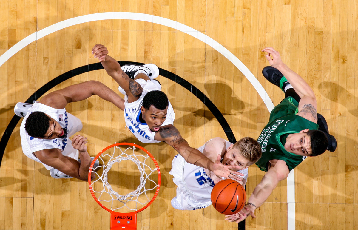 NFL player Sammis Reyes goes up for a rebound while playing for Tulane University's basketball team