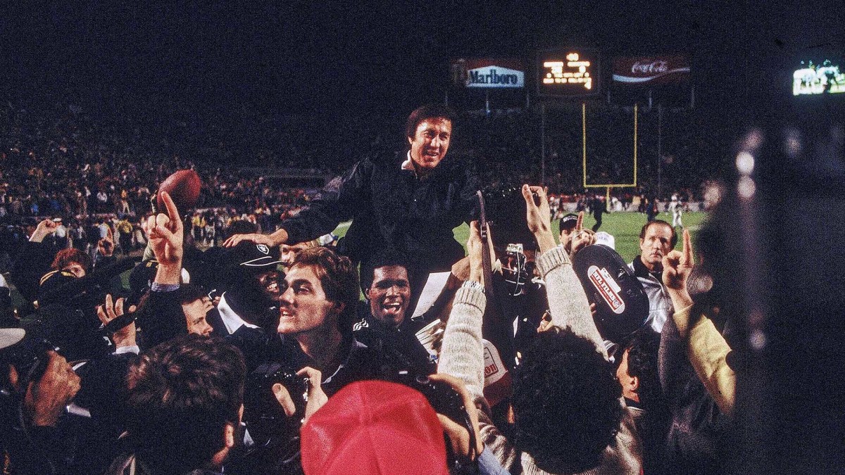 Tom Flores is carried off the field after Super Bowl XVIII