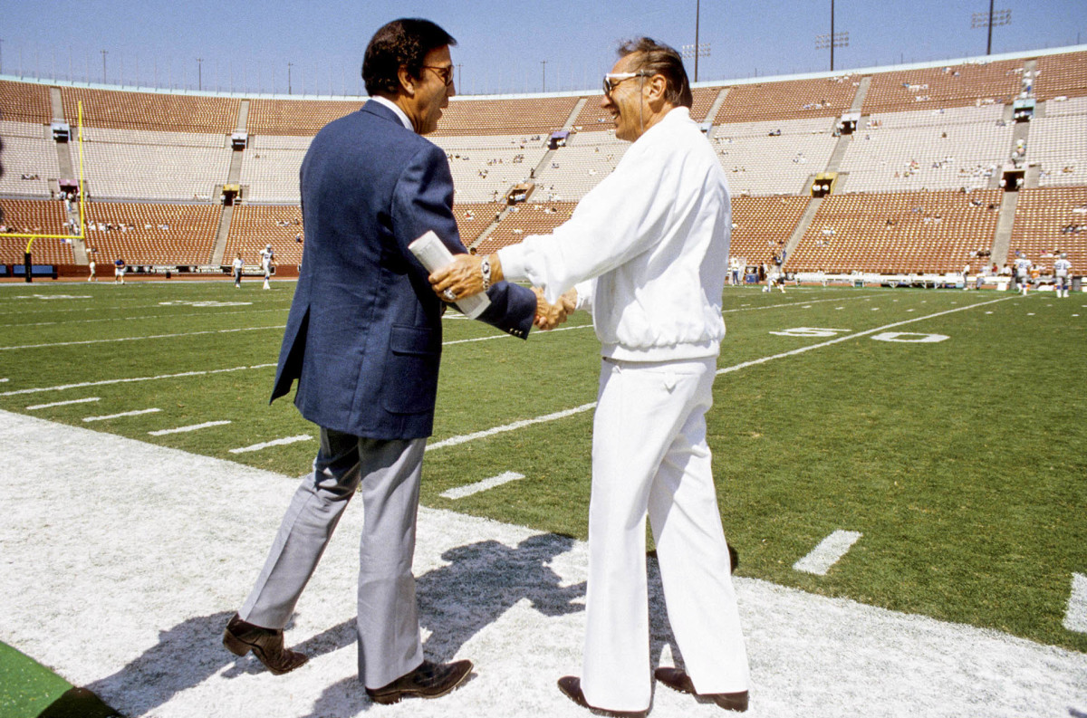 Tom Flores, then with the Seattle Seahawks, greets Raiders owner Al Davis before a game