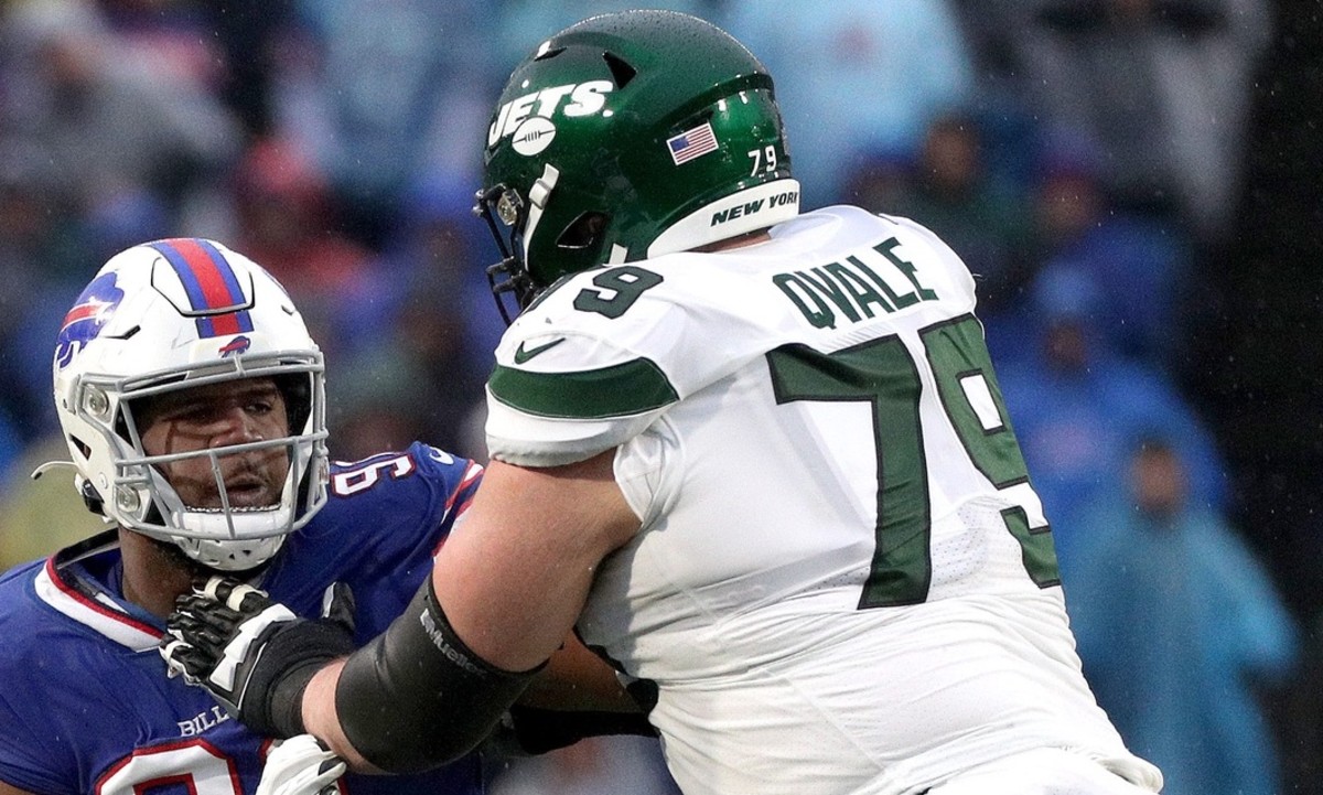 Bills defensive lineman Ed Oliver fights through a block by Jets Brent Qvale.