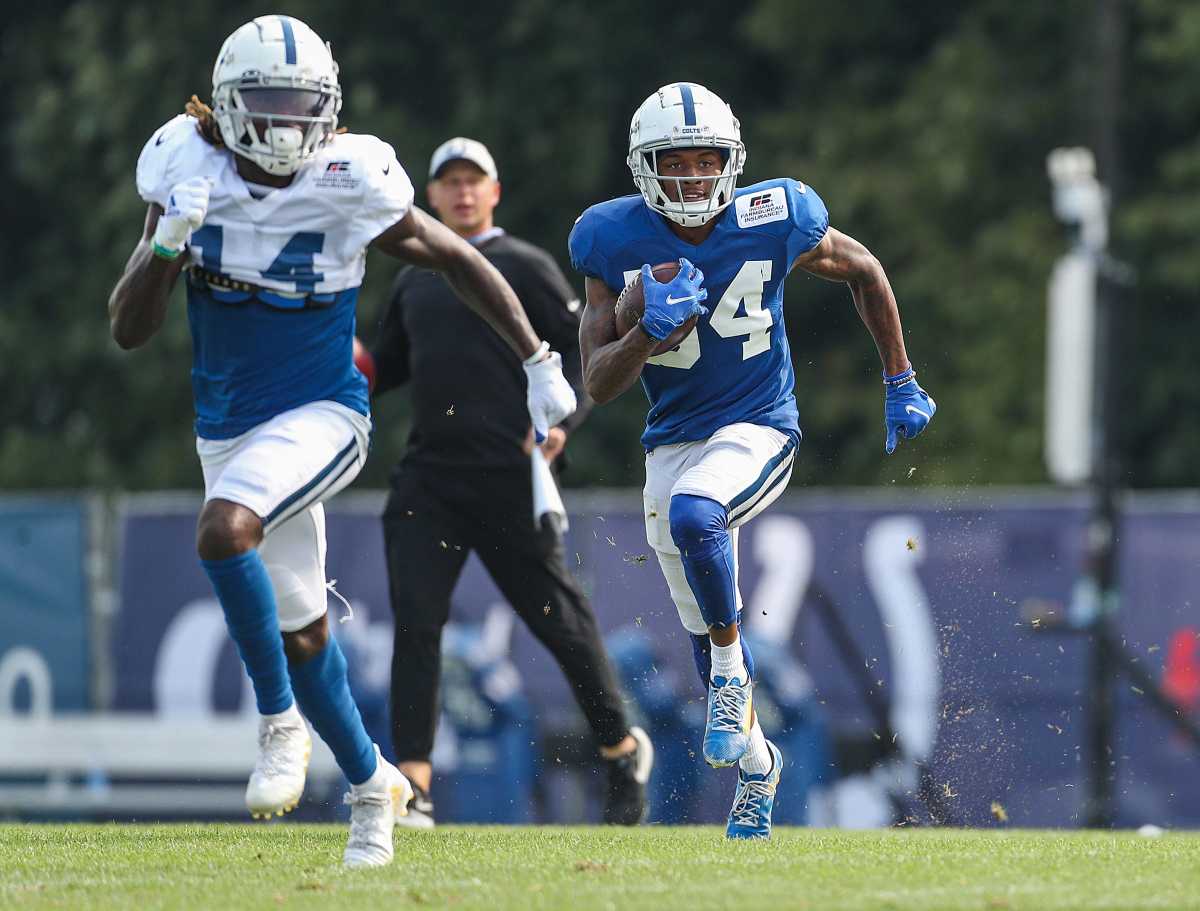 Indianapolis Colts wide receiver Zach Pascal (14) runs ahead of cornerback Isaiah Rodgers (34) who carries the ball during training camp Saturday, Aug. 7, 2021, at Grand Park in Westfield, Ind. Indianapolis Colts Training Camp At Grand Park In Westfield Indiana Saturday August 7 2021