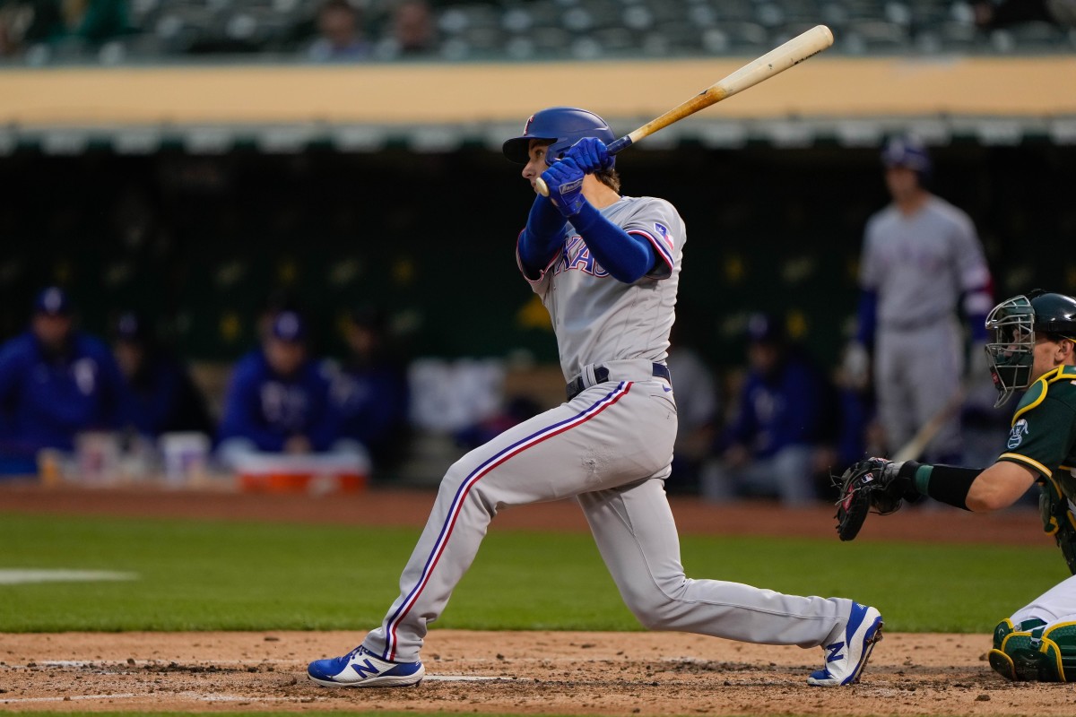 Jun 30, 2021; Oakland, California, USA; Texas Rangers shortstop Eli White (41) hits a double during the fifth inning against the Oakland Athletics at RingCentral Coliseum.