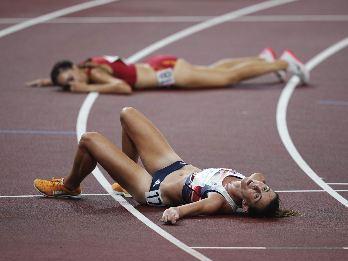 Jessica Judd (GBR), front, and Lucia Rodriguez (ESP) lay on the track after the women's 5000m preliminary, round one, heat one during the Tokyo 2020 Olympic Summer Games at Olympic Stadium.