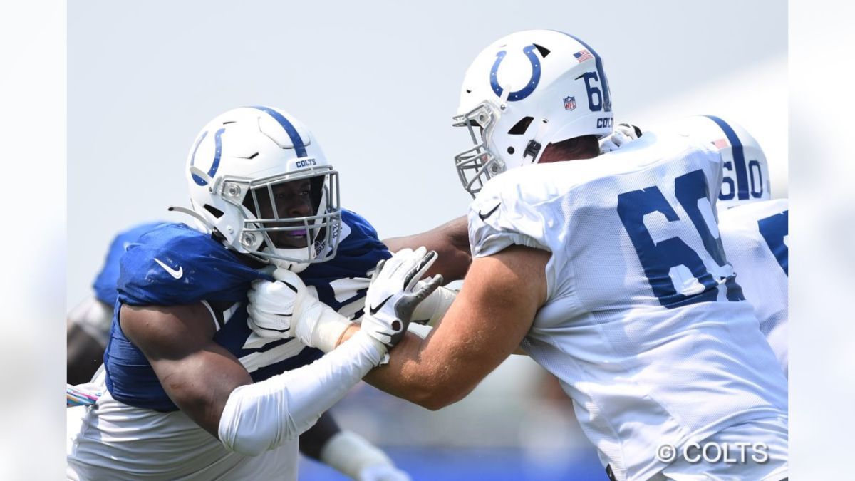 Indianapolis Colts offensive tackle Will Holden (69) blocking defensive end Ben Banogu (52) during 2021 training camp.