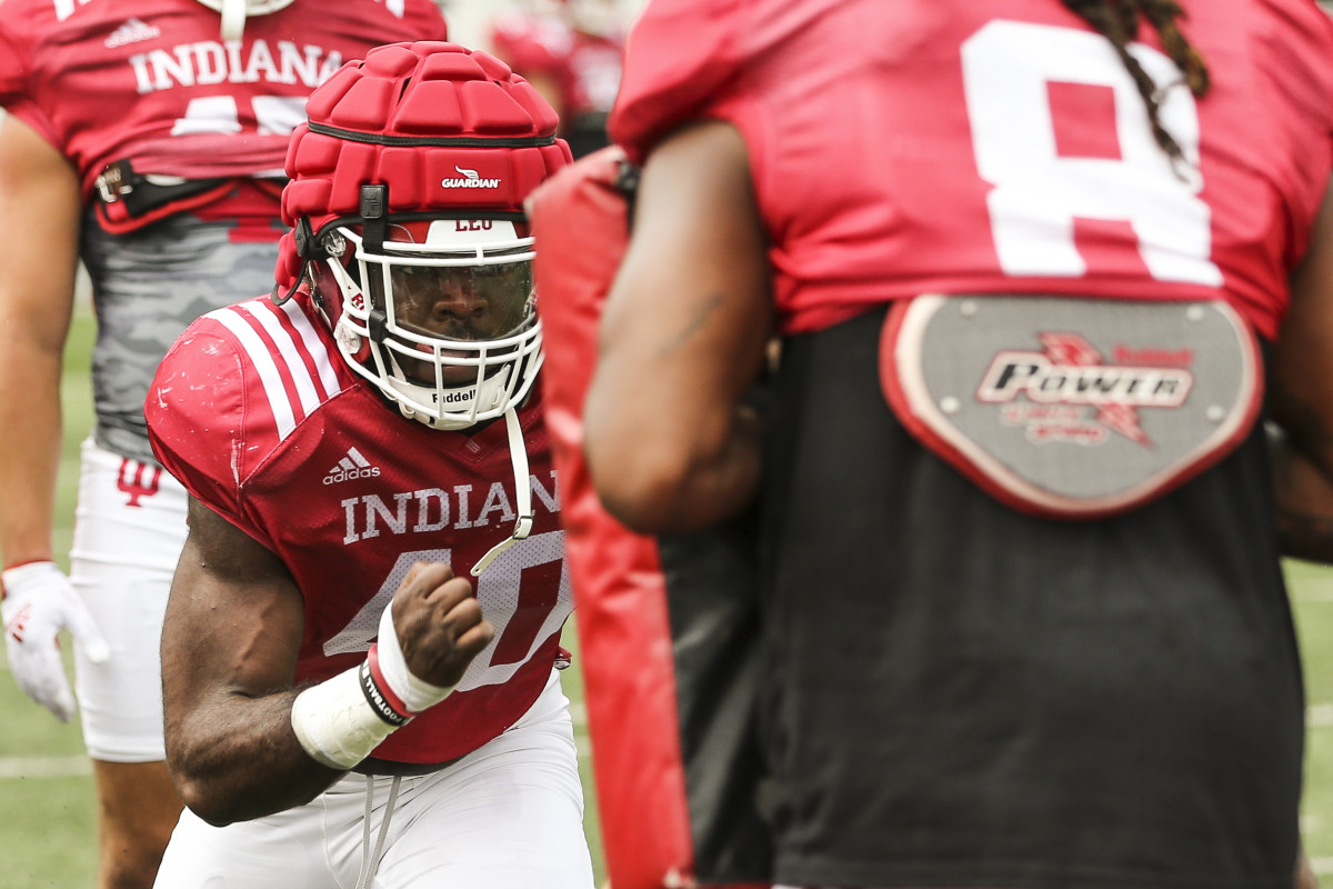 Linebacker Cam Williams pushes through pads during Indiana's fall camp practice on Aug. 9.