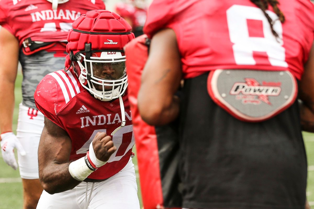 Linebacker Cam Williams pushes through pads during Indiana's fall camp practice on Aug. 9.