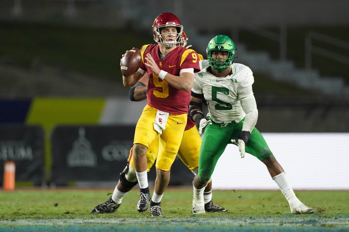 Dec 18, 2020; Los Angeles, California, USA; Southern California Trojans quarterback Kedon Slovis (9) is pressured by Oregon Ducks defensive end Kayvon Thibodeaux (5) in the second half during the Pac-12 Championship at United Airlines Field at Los Angeles Memorial Coliseum. Oregon defeated USC 31-24.