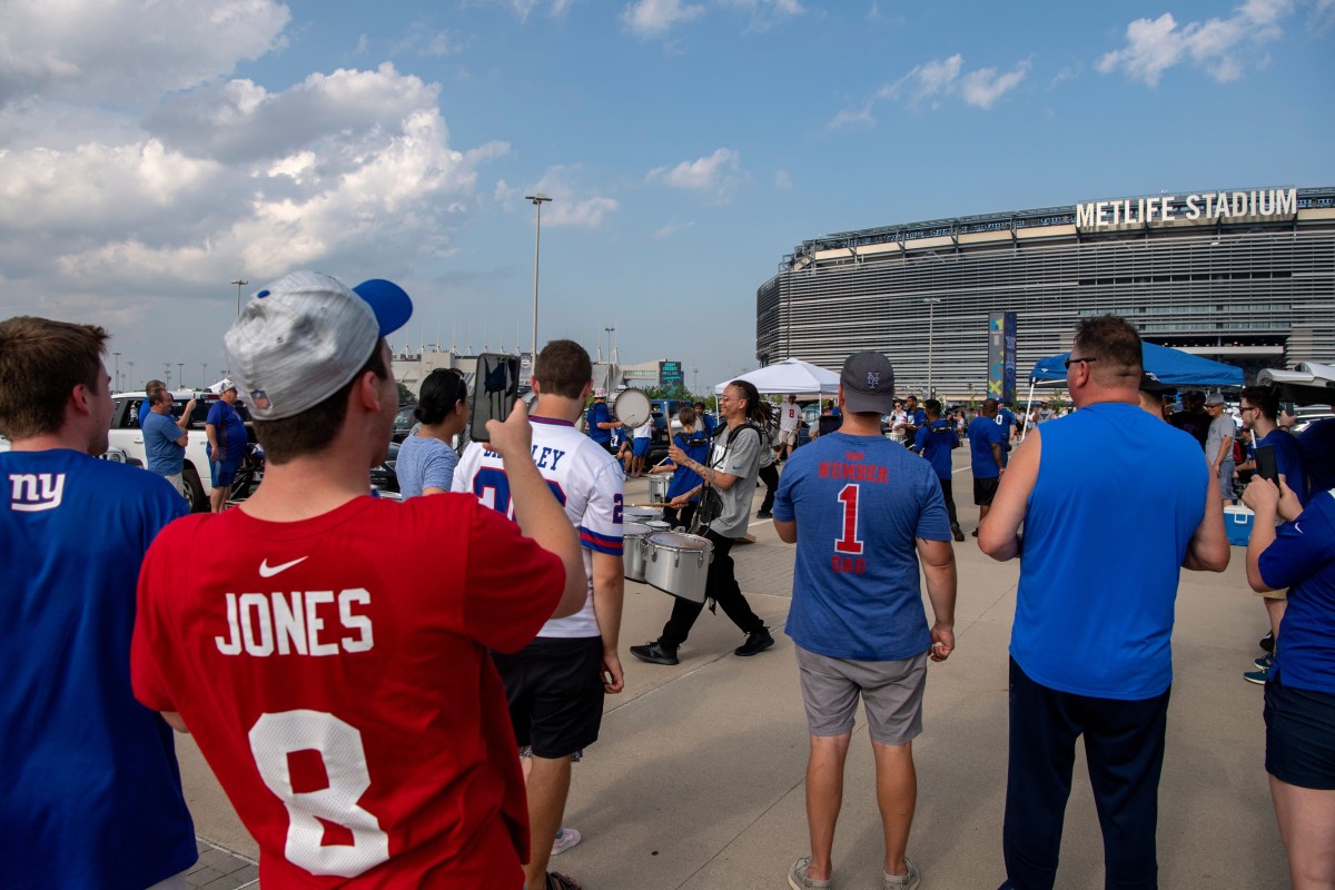 Fans watch a drumline outside of MetLife Stadium before the start of NY Giants Fan Fest on Wednesday, August 11, 2021.
