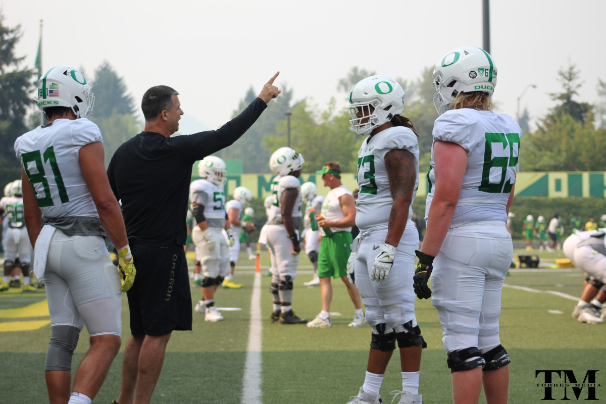 Mario Cristobal works through blocking drills with offensive linemen and tight ends.