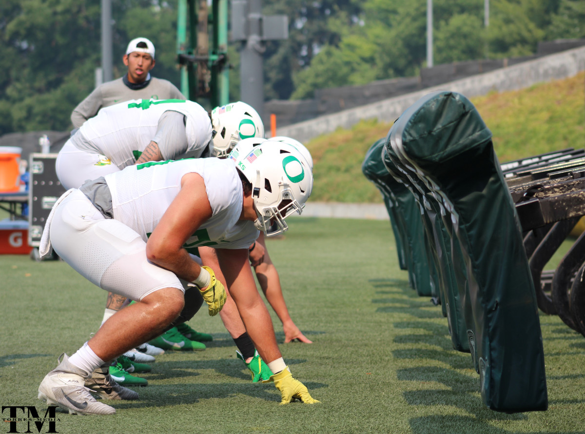 Patrick Herbert and the tight ends work on the sled in fall camp.