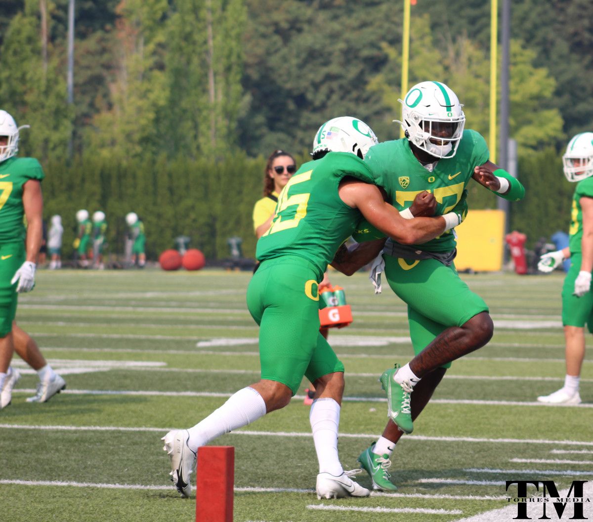 Bennett Williams wraps up Verone McKinley III in tackling drills.