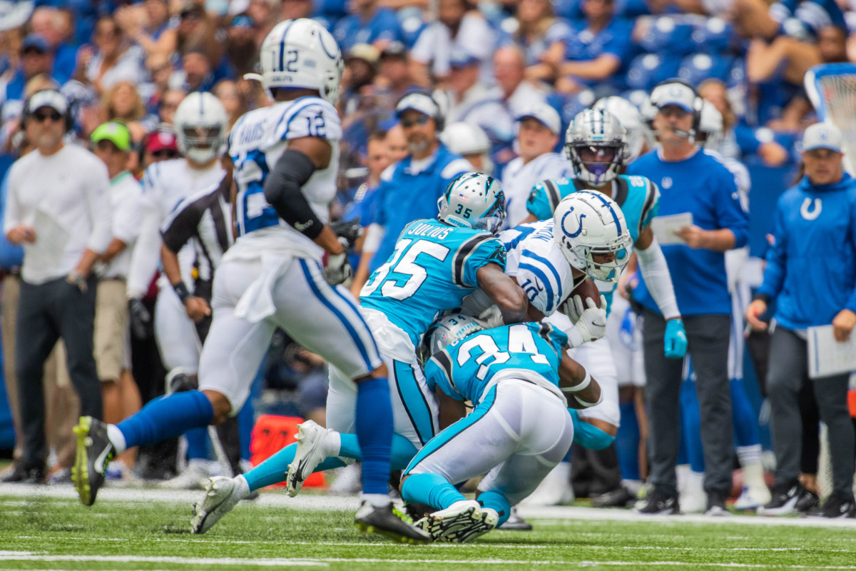 Aug 15, 2021; Indianapolis, Indiana, USA; Indianapolis Colts wide receiver Dezmon Patmon (10) runs with the ball while Carolina Panthers defensive back Jalen Julius (35) and defensive back Sean Chandler (34) defend in the first half at Lucas Oil Stadium. Mandatory Credit: Trevor Ruszkowski-USA TODAY Sports