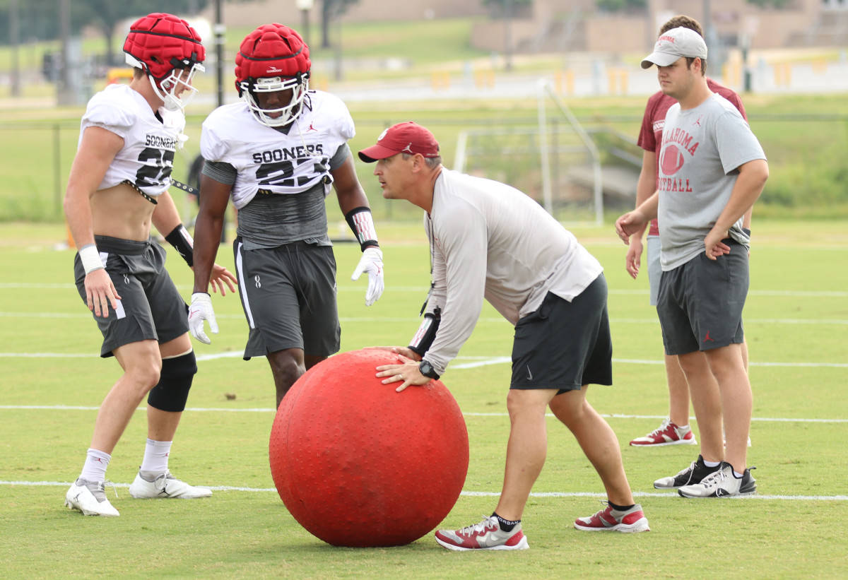 OU linebackers coach Brian Odom instructing his unit at practice 