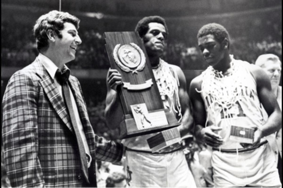 Quinn Buckner (right) celebrates winning the 1976 NCAA basketball championship with teammate Scott May and coach Bob Knight in Philadelphia. Buckner was named the first African American chair of the IU Board of Trustees on Tuesday. (Courtesy, USA TODAY Sports)