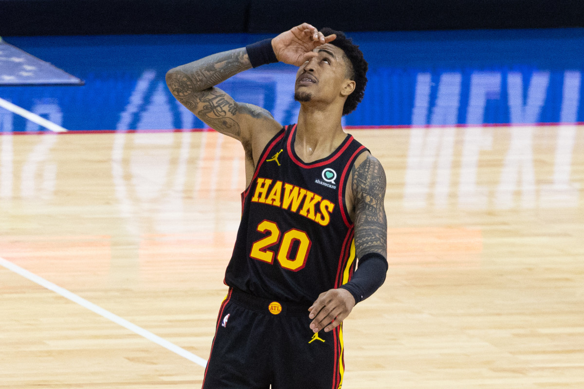 John Collins points to the sky during an NBA playoff game against Philadelphia 76ers