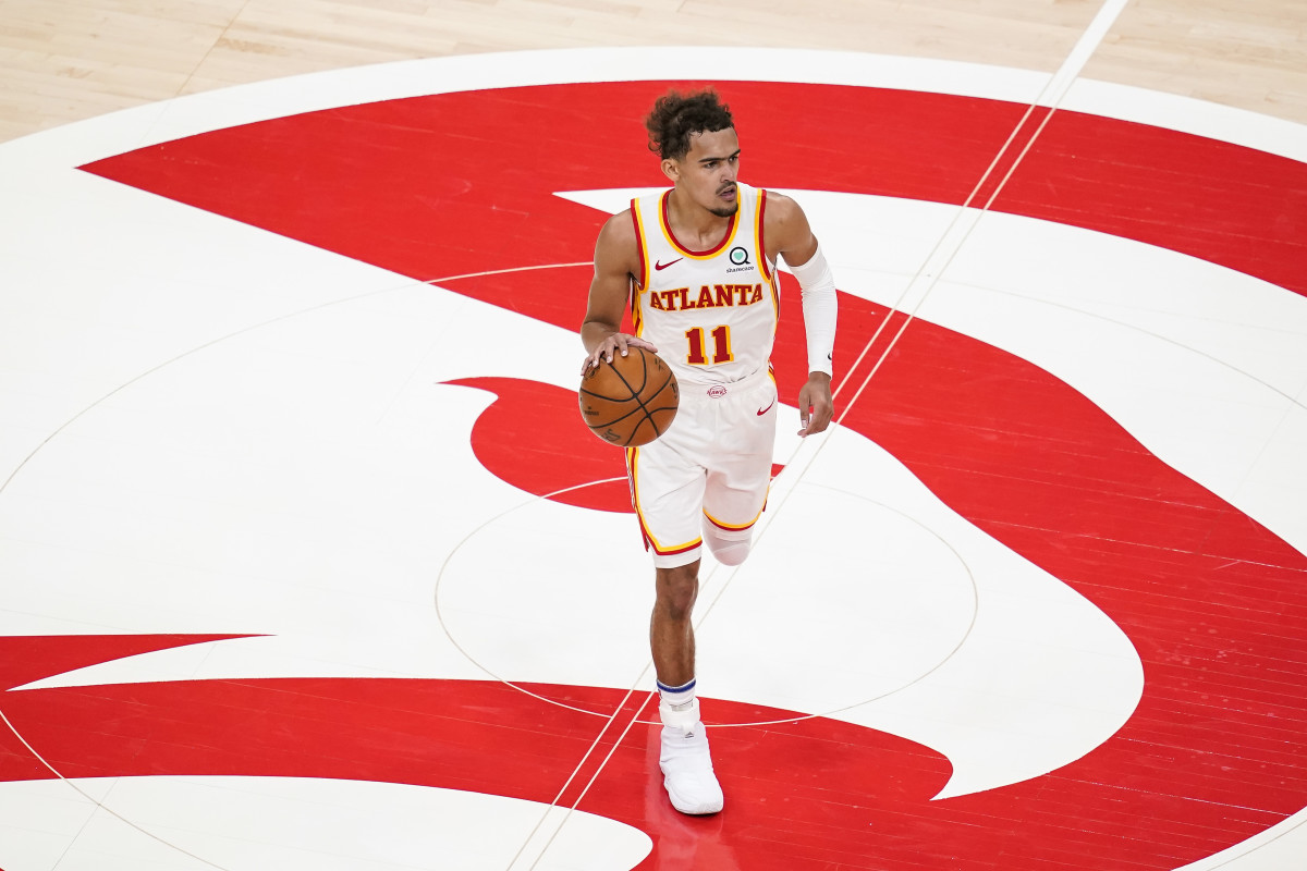 Atlanta Hawks guard Trae Young dribbles the ball at mid court against the Sacramento Kings