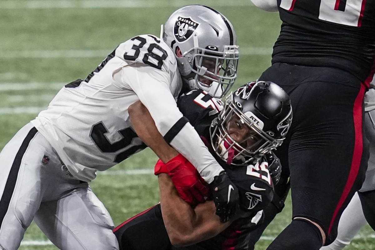 Falcons running back Ito Smith (25) is tackled by Raiders safety Jeff Heath (38). Mandatory Credit: Dale Zanine-USA TODAY Sports