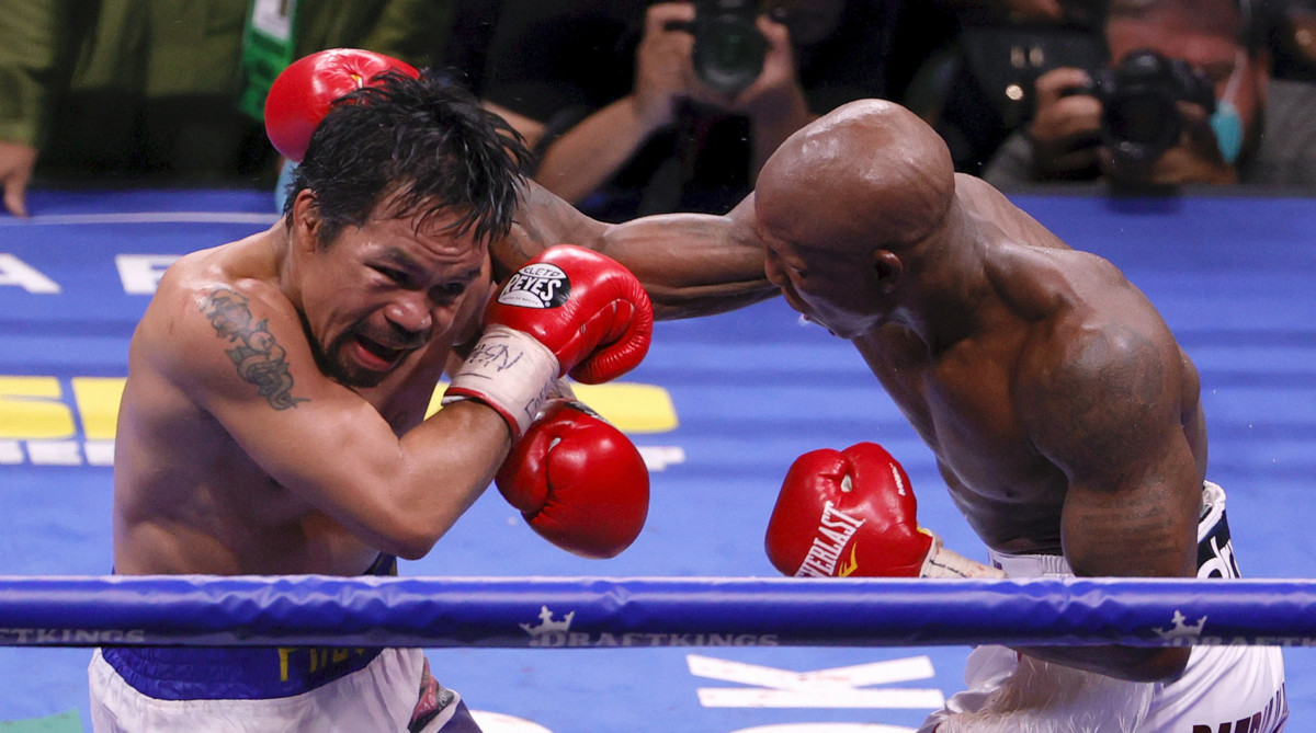 Manny Pacquiao (L) and Yordenis Ugas in the 10th round of their WBA welterweight title fight at T-Mobile Arena on August 21, 2021 in Las Vegas, Nevada. Ugas retained his title in a unanimous decision.