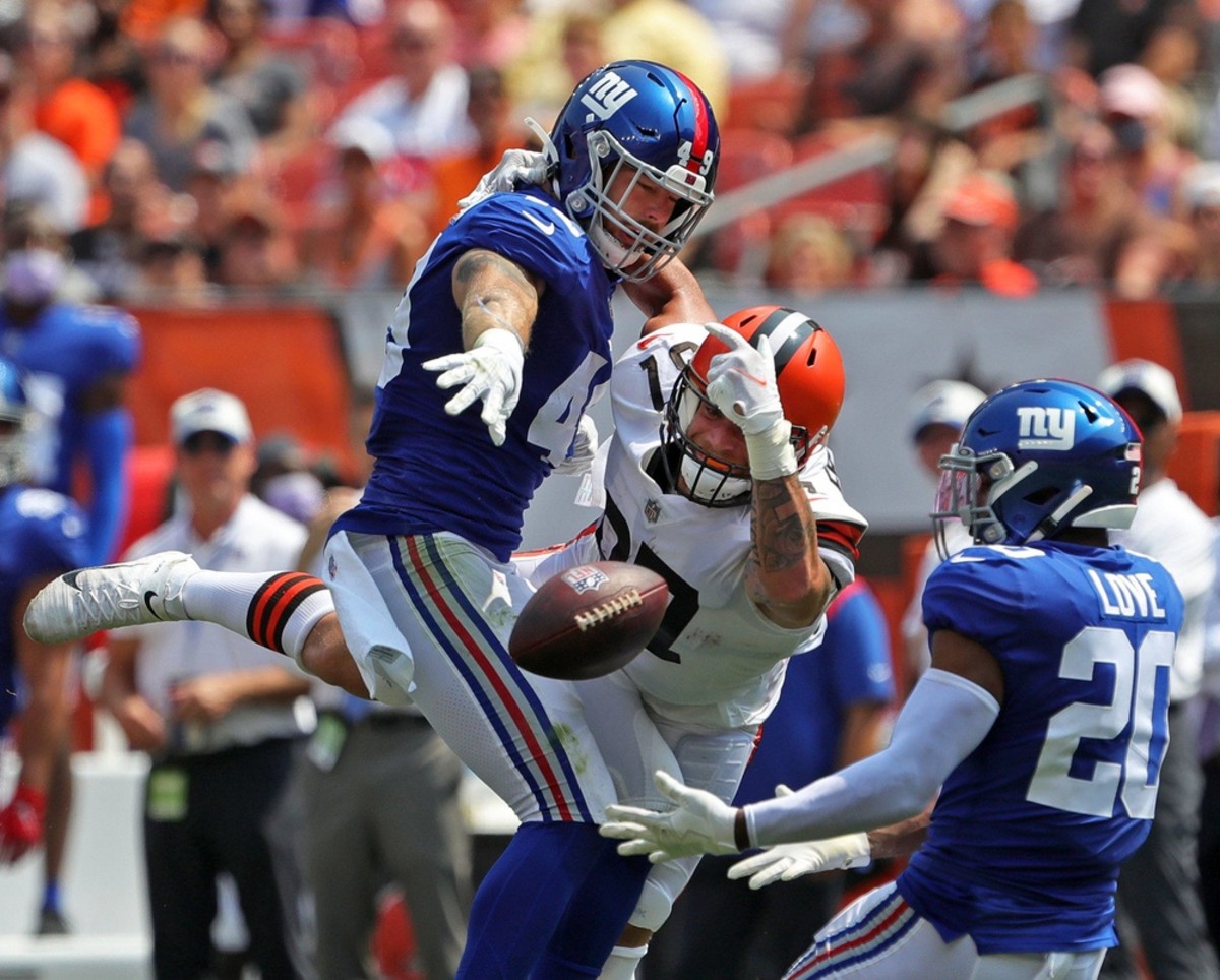 Cleveland Browns tight end Jordan Franks (87) gets tangled up with New York Giants linebacker Carter Coughlin (49) as he makes a play for a pass during the first half of an NFL preseason football game, Sunday, Aug. 22, 2021, in Cleveland, Ohio.