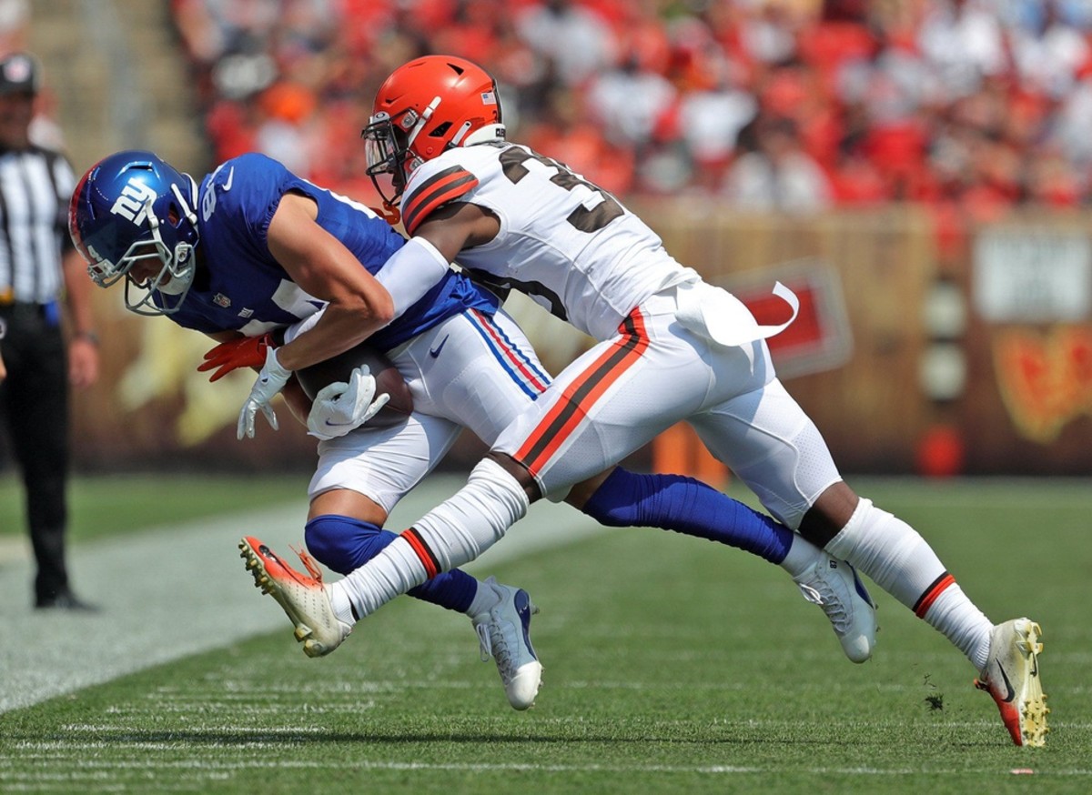 Cleveland Browns cornerback A.J. Green (38) tackles New York Giants wide receiver David Sills (84) out of bounds during the first half of an NFL preseason football game, Sunday, Aug. 22, 2021, in Cleveland, Ohio.