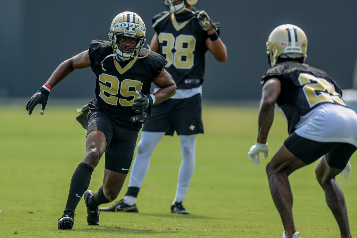 New Orleans Saints cornerbacks Paulson Adebo (29) and Ken Crawley (25) perform defensive drills during a training camp session. Mandatory Credit: Stephen Lew-USA TODAY