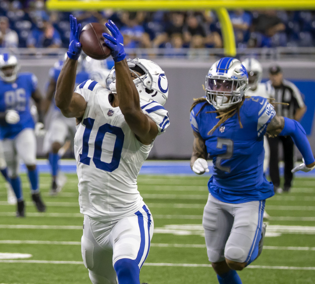 Aug 27, 2021; Detroit, Michigan, USA; Indianapolis Colts wide receiver Dezmon Patmon (10) makes a catch in front of Detroit Lions defensive back Mike Ford (2) in the second quarter at Ford Field.