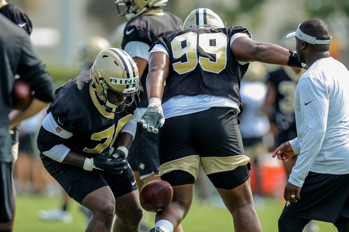 New Orleans Saints defensive linemen Shy Tuttle (99) and Christian Ringo (70) perform drills during a training camp session. Mandatory Credit: Stephen Lew-USA TODAY Sports