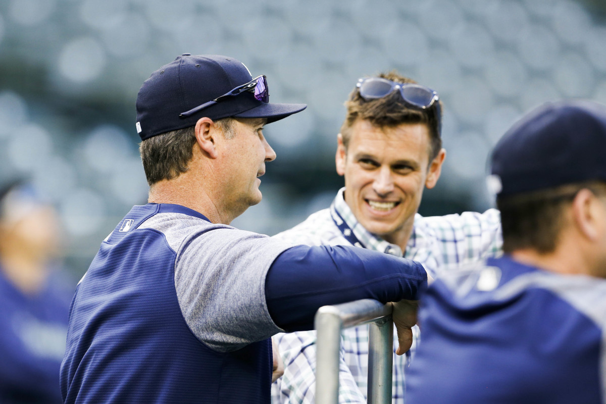 Scott Servais (left) talks with Jerry Dipoto (right).