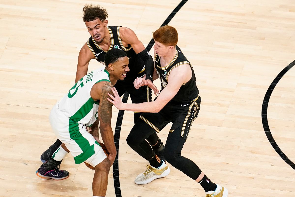 Boston Celtics guard Jeff Teague (55) gets hit in the face by Atlanta Hawks guard Kevin Huerter (3)