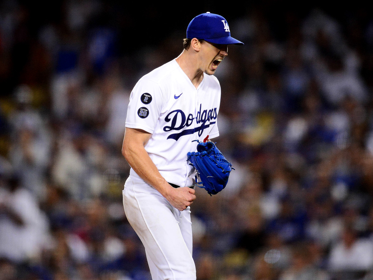 Aug 3, 2021; Los Angeles, California, USA; Los Angeles Dodgers starting pitcher Walker Buehler (21) reacts following the top of the sixth inning against the Houston Astros at Dodger Stadium.