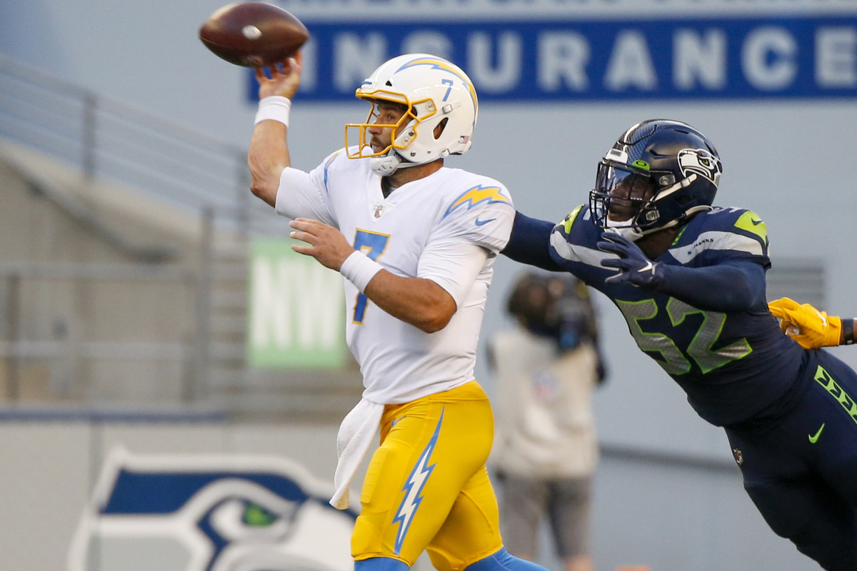 NFL: Los Angeles Chargers at Seattle Seahawks Aug 28, 2021; Seattle, Washington, USA; Los Angeles Chargers quarterback Chase Daniel (7) throws a pass under pressure from Seattle Seahawks defensive end Darrell Taylor (52) during the first quarter at Lumen Field. Mandatory Credit: Joe Nicholson-USA TODAY Sports