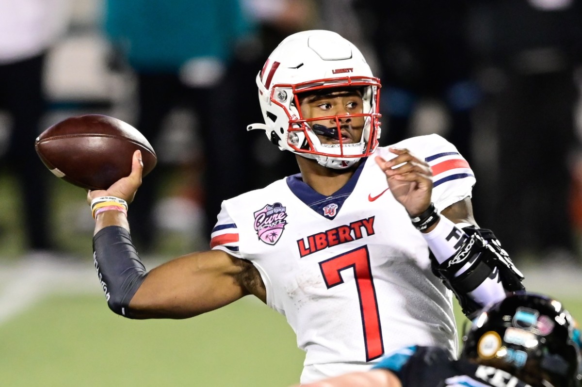 Liberty Flames quarterback Malik Willis (7) looks to pass the ball during the second quarter against the Coastal Carolina Chanticleers during the Cure Bowl at Camping World Stadium.