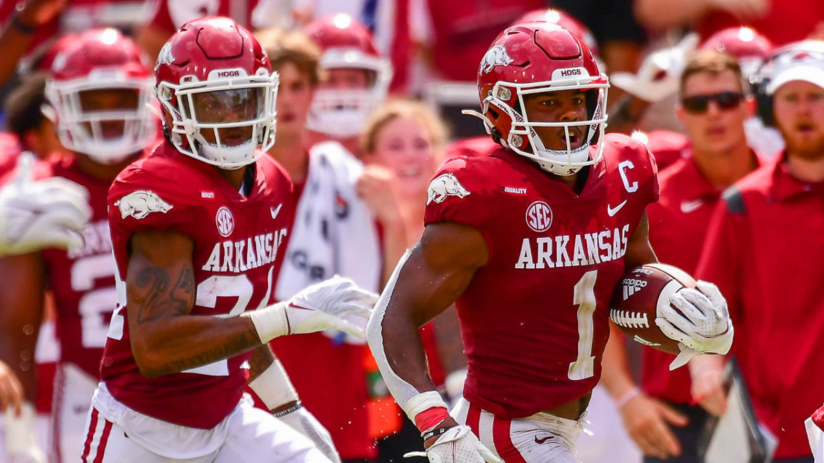 Arkansas safety Jalen Catalon returns an interception against Rice while getting an escort by fellow defensive LaDarrius Bishop. It was one of two interceptions for Catalon for the game.
