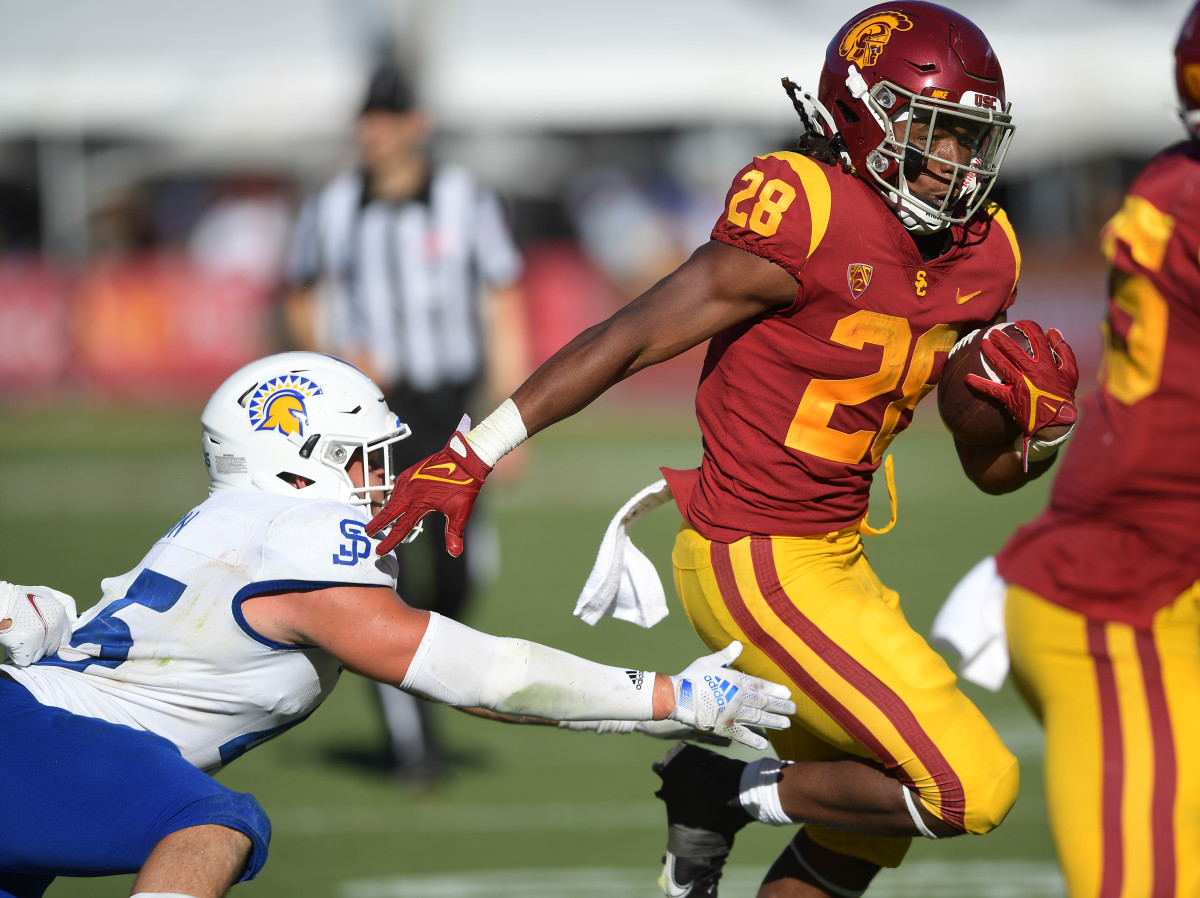 USC running back Keontay Ingram (28) escapes a tackle from a San Jose State defender.