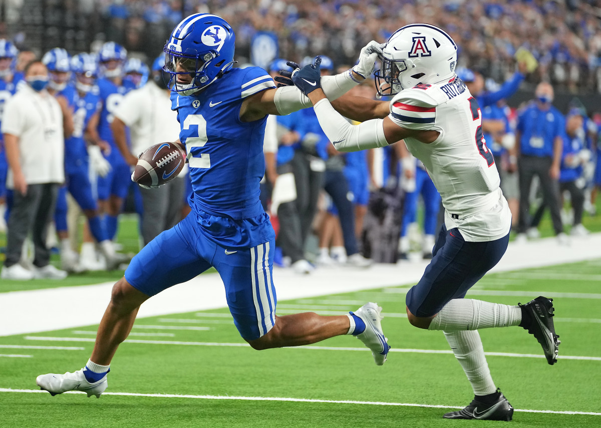 BYU wide receiver Neil Pau'u (2) evades the tackle attempt of Arizona cornerback Isaiah Rutherford (2).