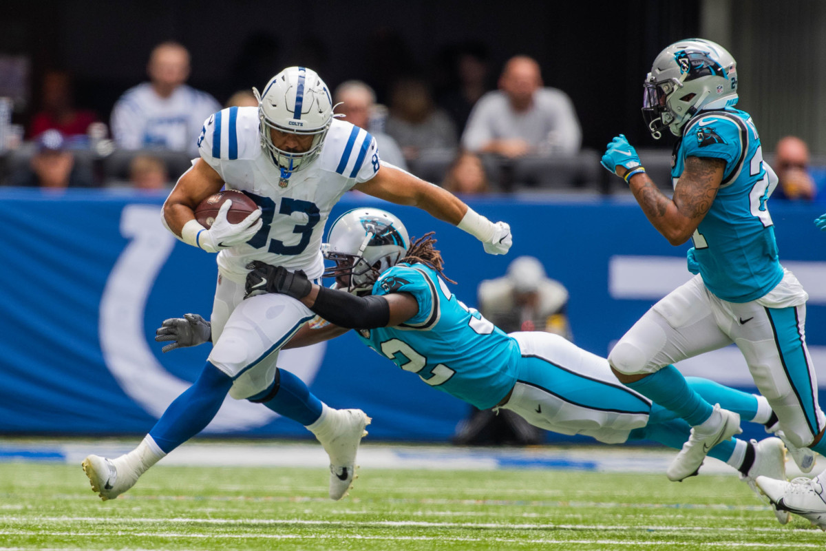 Aug 15, 2021; Indianapolis, Indiana, USA; Indianapolis Colts tight end Kylen Granson (83) runs with the ball while Carolina Panthers linebacker Josh Bynes (32) defends in the second half at Lucas Oil Stadium.