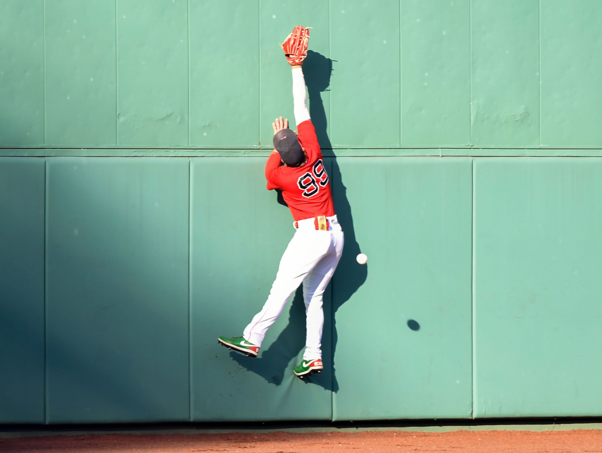 Boston Red Sox left fielder Alex Verdugo (99) was unable to catch a ball hit by Tampa Bay Rays designated hitter Austin Meadows (not seen) during the ninth inning at Fenway Park.