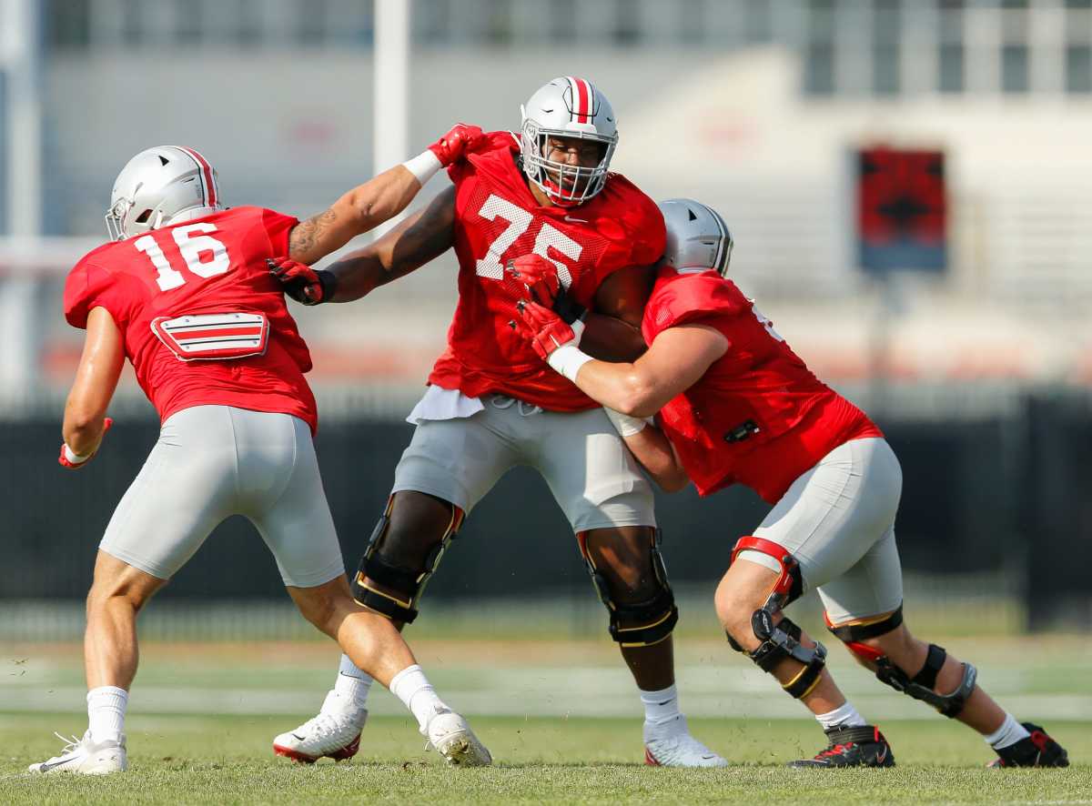 Offensive lineman Thayer Munford (75) blocks tight end Cade Stover (16) and offensive lineman Zen Michalski (65) during football camp at the Woody Hayes Athletic Center in Columbus.