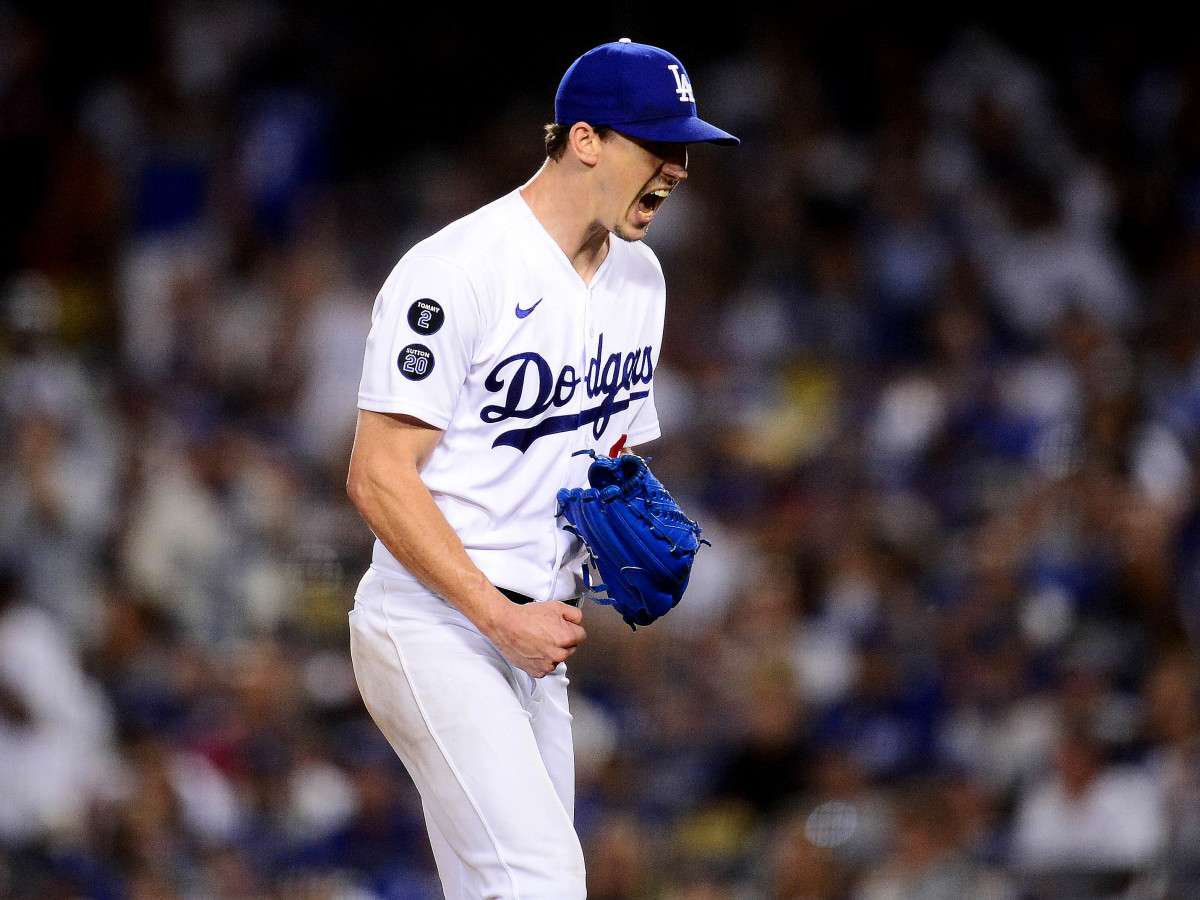 Aug 3, 2021; Los Angeles, California, USA; Los Angeles Dodgers starting pitcher Walker Buehler (21) reacts following the top of the sixth inning against the Houston Astros at Dodger Stadium.