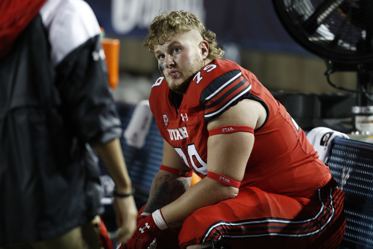 Utah offensive lineman Alex Harrison (79) sits dejected on the bench after the loss to BYU.