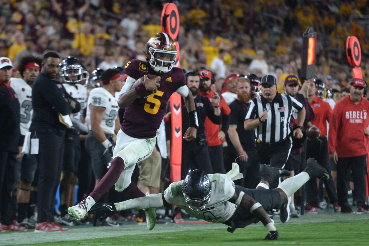 Arizona State quarterback Jayden Daniels (5) runs by UNLV linebacker Jacoby Windmon (4).