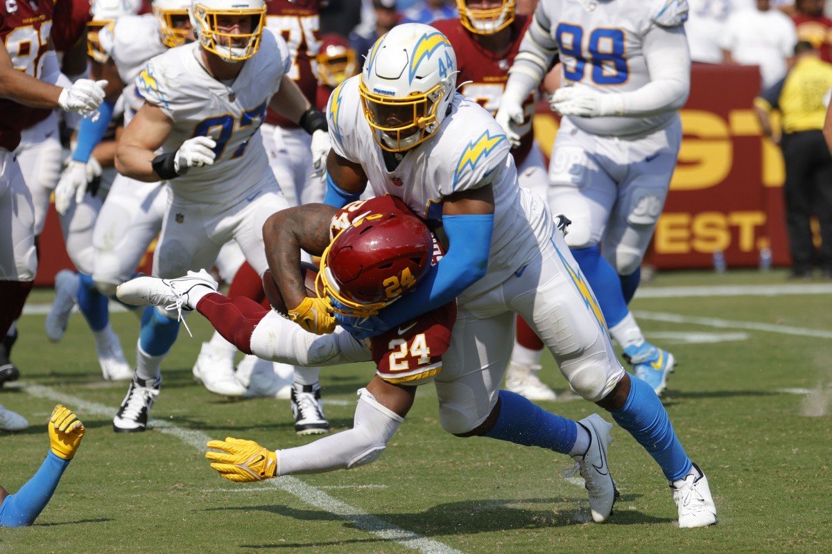 Sep 12, 2021; Landover, Maryland, USA; Washington Football Team running back Antonio Gibson (24) fumbles the ball on a hit by Los Angeles Chargers linebacker Kyzir White (44) in the fourth quarter at FedExField.