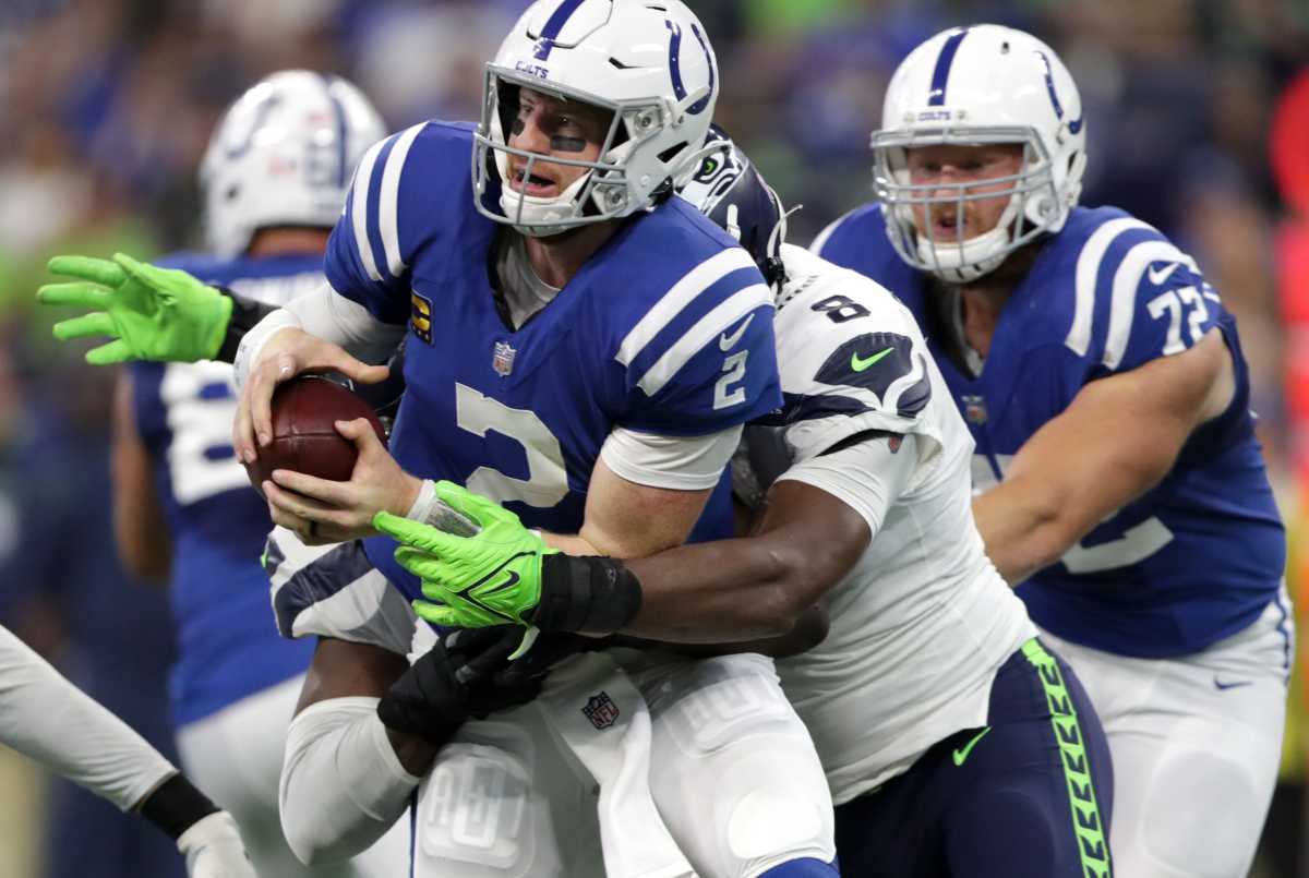 Indianapolis Colts quarterback Carson Wentz (2) is wrapped up by Seattle Seahawks defensive end Carlos Dunlap (8) on Sunday, Sept. 12, 2021, during the regular season opener at Lucas Oil Stadium in Indianapolis.